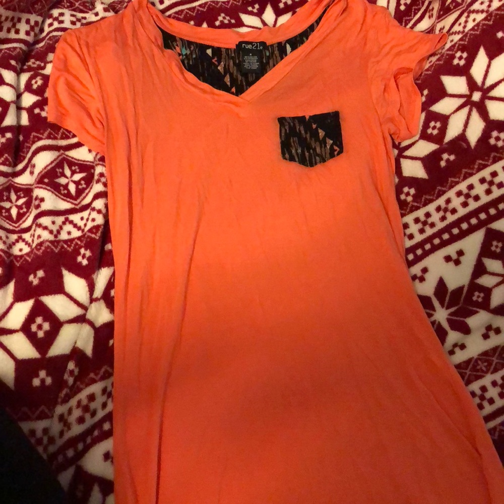 Peach and multi colored t shirt.